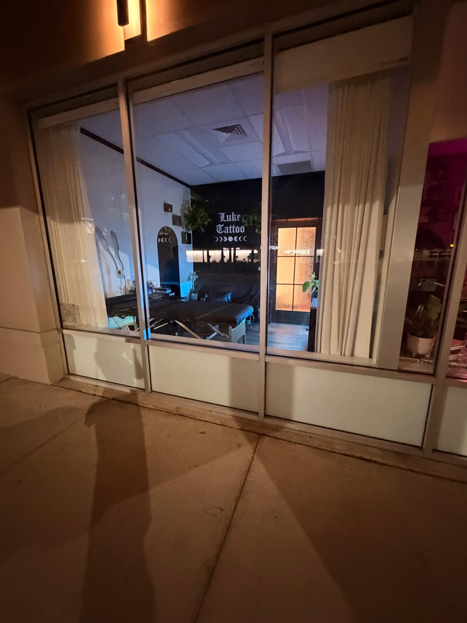 Luke Tattoo studio storefront at night